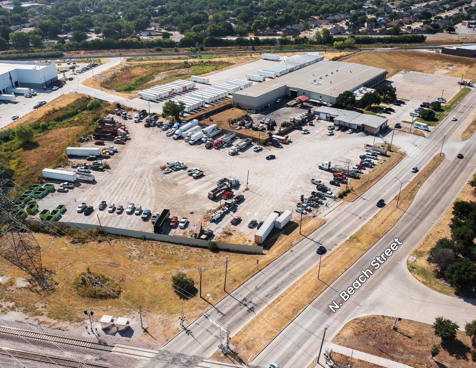 Aerial of an industrial outdoor storage site near a highway